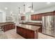Spacious kitchen featuring a large island and stainless steel refrigerator at 9237 W Alex Ave, Peoria, AZ 85382