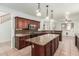 Spacious kitchen with granite counters, island and stainless microwave oven at 9237 W Alex Ave, Peoria, AZ 85382