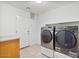 Bright laundry room features Samsung washer/dryer and tile floors at 9237 W Alex Ave, Peoria, AZ 85382