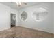 Open living room with unique wall cutouts and neutral carpet at 9237 W Alex Ave, Peoria, AZ 85382