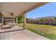 Covered patio with stone floors overlooking a large grassy backyard at 9237 W Alex Ave, Peoria, AZ 85382