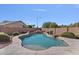 This backyard pool features natural rock accents and mature desert landscaping at 9237 W Alex Ave, Peoria, AZ 85382