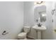 Cozy powder room with pedestal sink, and neutral wall color at 9237 W Alex Ave, Peoria, AZ 85382