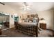 Comfortable bedroom featuring a large bed, ceiling fan, and a mirrored closet at 9263 E Monterey Ave, Mesa, AZ 85209