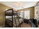 Bedroom featuring bunk beds, a window with blinds, and a small dresser with a lamp at 9263 E Monterey Ave, Mesa, AZ 85209