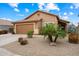 Charming single-story home featuring a tile roof, two-car garage, and desert landscaping with a lovely palm tree at 9263 E Monterey Ave, Mesa, AZ 85209
