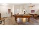 Spacious game room featuring a pool table, unique barrel table set, and decorative tile flooring throughout at 9263 E Monterey Ave, Mesa, AZ 85209