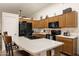Well-equipped kitchen featuring a breakfast bar, dark appliances, and ample cabinet space for storage at 9263 E Monterey Ave, Mesa, AZ 85209