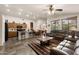 Open-concept living space featuring a modern kitchen, dining area, and comfortable seating with stylish decor at 9263 E Monterey Ave, Mesa, AZ 85209