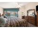Comfortable main bedroom featuring pool views, ceiling fan, and access to an office area at 9263 E Monterey Ave, Mesa, AZ 85209