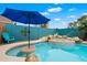 Inviting backyard pool with a built-in spa and baja shelf, perfect for relaxation and fun at 9263 E Monterey Ave, Mesa, AZ 85209