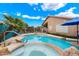 Inviting pool and spa combination with lush desert landscaping and a patio area at 9263 E Monterey Ave, Mesa, AZ 85209