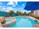 Gorgeous backyard pool with a spa, water feature, and desert landscaping at 9263 E Monterey Ave, Mesa, AZ 85209