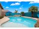 Stunning pool with rock features and lush landscaping creates a serene backyard oasis at 9263 E Monterey Ave, Mesa, AZ 85209