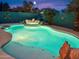 Backyard pool area with a spa and palm trees against a colorful sunset sky at 9263 E Monterey Ave, Mesa, AZ 85209