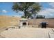 Private backyard with a brick fireplace and an outdoor grill, perfect for entertaining at 9658 E Olla Ave, Mesa, AZ 85212