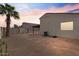 Spacious backyard with a palm tree, block wall, and a neutral-colored home and detached garage or casita at 9718 E Boston St, Mesa, AZ 85207