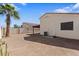 Spacious backyard features a palm tree, neutral color walls, and potential for customization at 9718 E Boston St, Mesa, AZ 85207