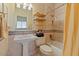 Luxurious bathroom featuring decorative tile, a pedestal sink, and bathtub with shower at 9718 E Boston St, Mesa, AZ 85207