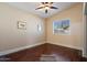 Bedroom with hardwood floors, a ceiling fan, and a bright window at 9718 E Boston St, Mesa, AZ 85207
