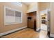 Bedroom featuring a large window, closet space, and doorway leading to the kitchen at 9718 E Boston St, Mesa, AZ 85207