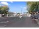 Gated community entrance with manicured landscaping and secure access for residents and visitors at 9718 E Boston St, Mesa, AZ 85207