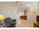 Open-concept living area with tile flooring, ceiling fan, neutral paint tones, and views into kitchen at 9718 E Boston St, Mesa, AZ 85207