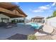 Resort-style pool area with lounge chairs, covered seating, and lush landscaping at 9718 E Boston St, Mesa, AZ 85207