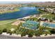 An aerial shot captures a serene lake surrounded by homes and well-manicured community amenities at 9734 S 182Nd Dr, Goodyear, AZ 85338