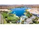 Breathtaking aerial view of community lake, pool, and lush landscaping, with desert mountains in the background at 9734 S 182Nd Dr, Goodyear, AZ 85338