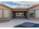 Covered patio leads to the backyard with desert landscaping and an in-ground spa at 9734 S 182Nd Dr, Goodyear, AZ 85338