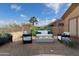 Outdoor seating area with a sofa and chairs surrounding a fire pit at 9734 S 182Nd Dr, Goodyear, AZ 85338