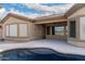 Inviting backyard with a shimmering pool, providing a serene retreat for leisure and relaxation, with a covered patio at 9734 S 182Nd Dr, Goodyear, AZ 85338
