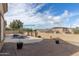 This backyard features a private pool, a spacious brick patio area, and desert landscaping for low maintenance at 9734 S 182Nd Dr, Goodyear, AZ 85338