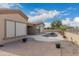Beautiful backyard with a private pool and spa, surrounded by desert landscaping and a spacious patio area at 9734 S 182Nd Dr, Goodyear, AZ 85338
