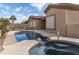 Well-maintained backyard with a pool and spa, perfect for relaxation and outdoor enjoyment, complemented by mature landscaping at 9734 S 182Nd Dr, Goodyear, AZ 85338