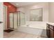 Bathroom with a large soaking tub, separate shower with a glass door and updated fixtures at 9734 S 182Nd Dr, Goodyear, AZ 85338