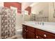 Well-lit bathroom with tile floors, single vanity and a shower and tub combo at 9734 S 182Nd Dr, Goodyear, AZ 85338