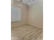 Comfortable bedroom with wood-style tile flooring, a ceiling fan, and a window with blinds, offering a simple design at 9734 S 182Nd Dr, Goodyear, AZ 85338