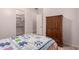 Bedroom with a large bed, wooden closet, view into the hallway and walk in closet at 9734 S 182Nd Dr, Goodyear, AZ 85338