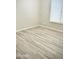 Light-filled bedroom with wood-style tile flooring and a window providing natural light, creating a cozy atmosphere at 9734 S 182Nd Dr, Goodyear, AZ 85338