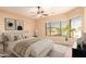 Staged bedroom with a cozy bed, stylish decor, and large windows offering a tranquil and inviting atmosphere at 9734 S 182Nd Dr, Goodyear, AZ 85338