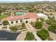 Aerial view of community clubhouse with pool, tile roof, and beautiful desert landscaping at 9734 S 182Nd Dr, Goodyear, AZ 85338