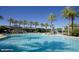 Expansive community pool with water features and adjacent clubhouse, ideal for Gathering fun at 9734 S 182Nd Dr, Goodyear, AZ 85338