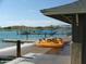 View of a dock with a paddle boat and surrounding lake at 9734 S 182Nd Dr, Goodyear, AZ 85338