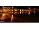 Picturesque waterfront community with a beautiful lake view and lighted dock at night at 9734 S 182Nd Dr, Goodyear, AZ 85338