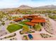 Stunning aerial view of a luxurious home with an inviting pool and well-manicured lawn and mountain views at 9734 S 182Nd Dr, Goodyear, AZ 85338