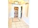 Inviting foyer featuring a decorative tile inlay, a rustic wood door, and an arched alcove niche at 9734 S 182Nd Dr, Goodyear, AZ 85338