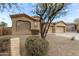 Charming home with a well-maintained desert landscape, three car garage, and neutral stucco at 9734 S 182Nd Dr, Goodyear, AZ 85338