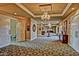Elegant hallway with decorative ceilings, ornate chandeliers, and patterned flooring, offering a sophisticated ambiance at 9734 S 182Nd Dr, Goodyear, AZ 85338